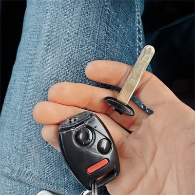 Customer holding car keys and a remote key fob