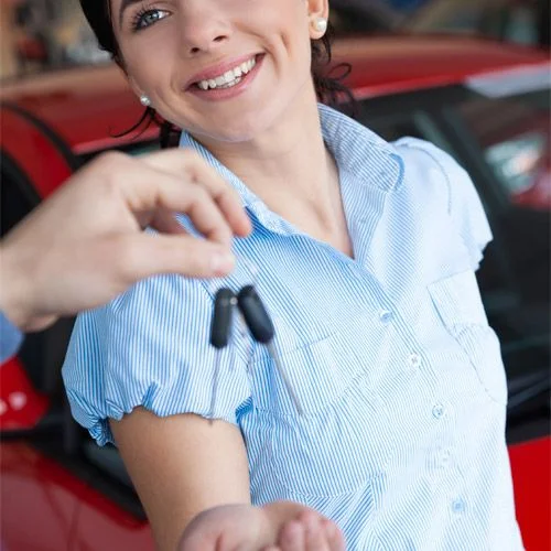Smiling customer holding her car keys after service